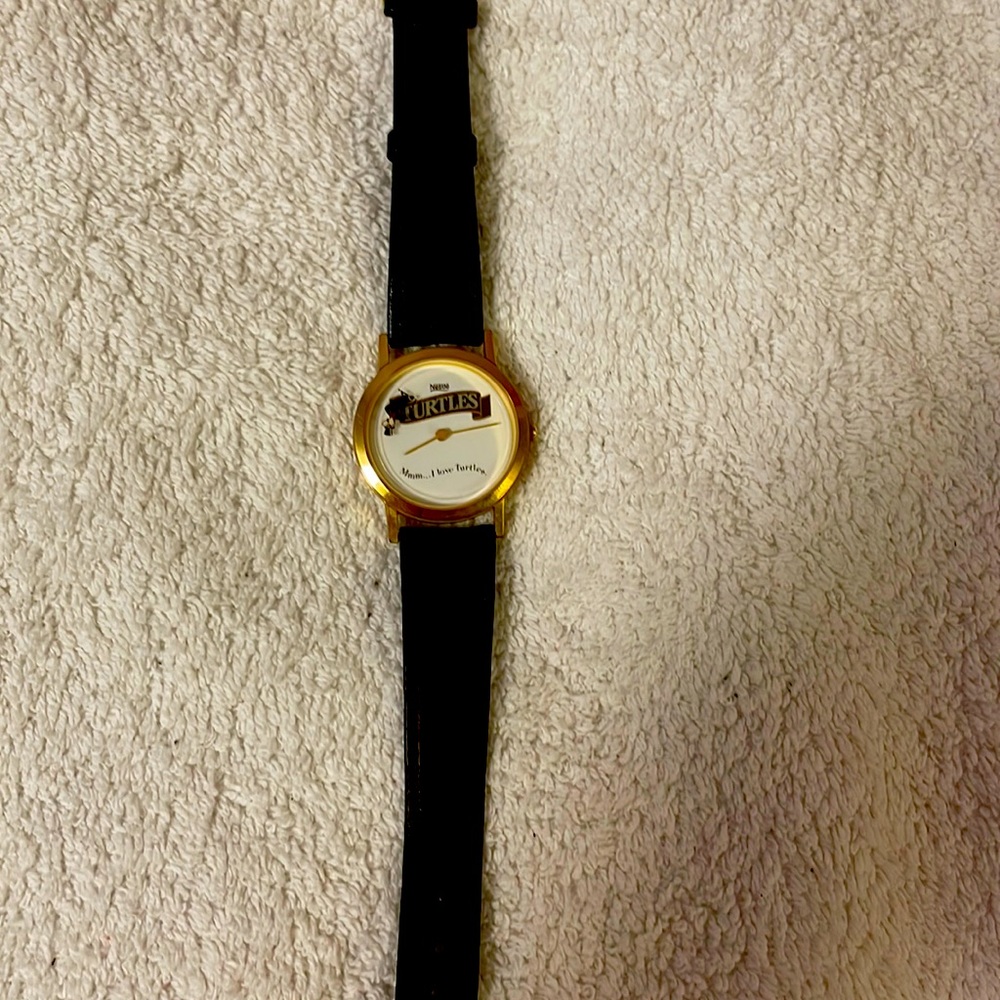 Watch branded “nestle turtles”. Leather adjustable strap.